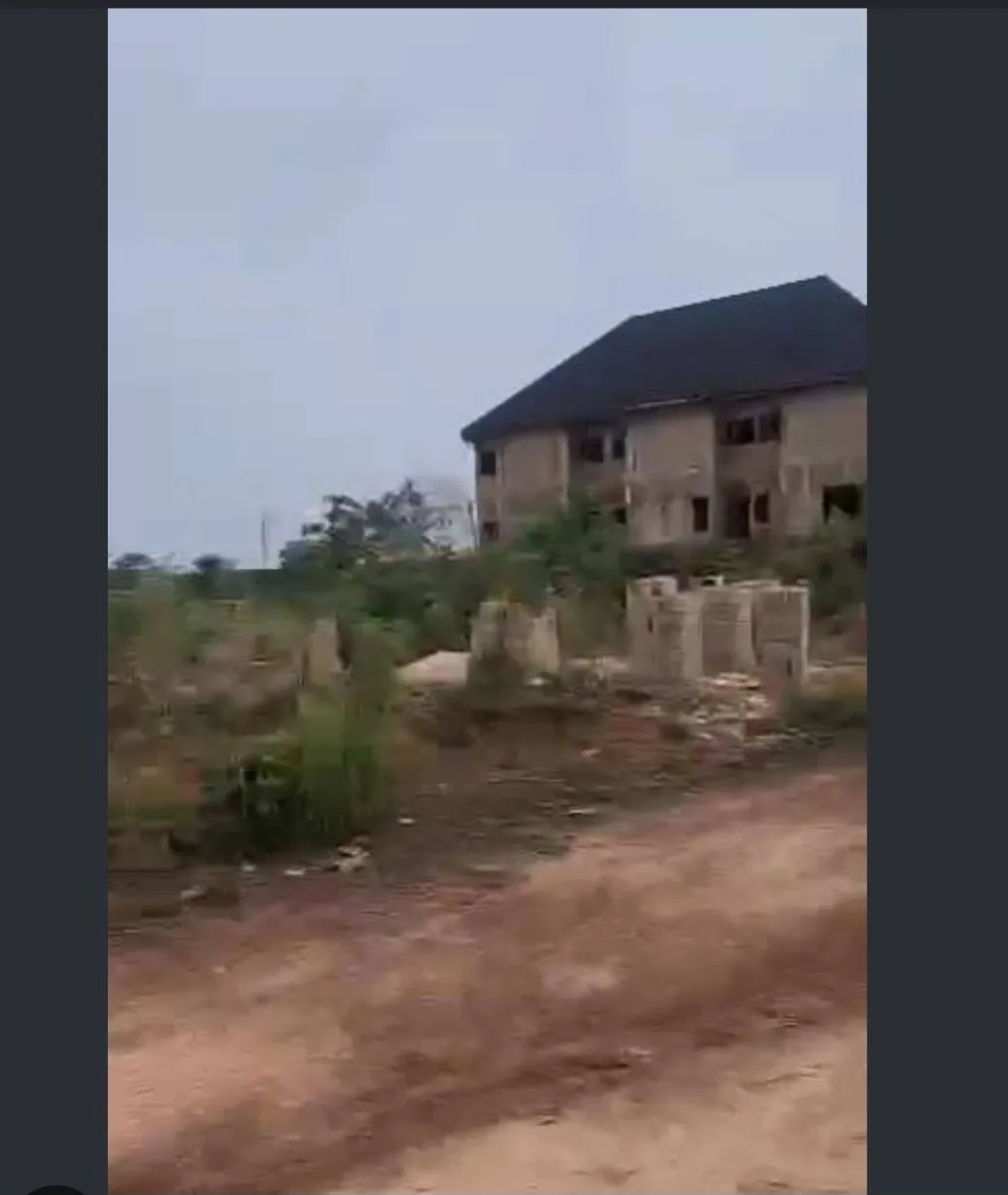 Unfinished house beside a dirt road at Magical Tower County Homes, Centenary, Enugu